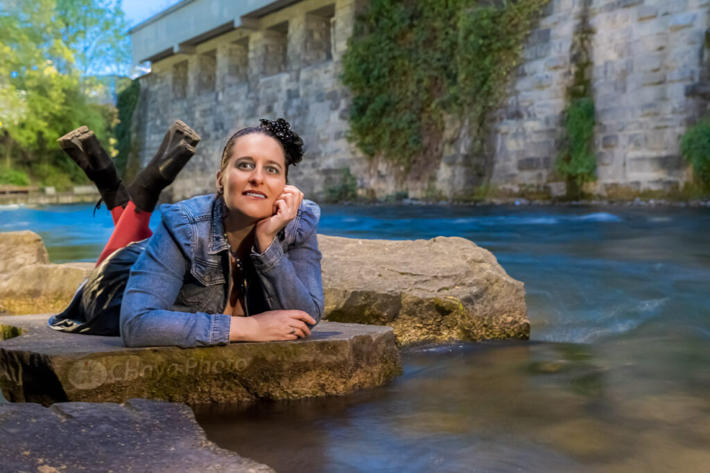 a gorgeous model laying on a rock